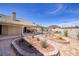The backyard has a covered patio, pool, outdoor grill, all set amidst beautiful desert landscaping at 190 Channel Dr, Henderson, NV 89002