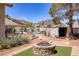 Backyard featuring a pool, landscaped yard, and a built-in fire pit with mountain views at 190 Channel Dr, Henderson, NV 89002