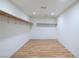 Walk in closet featuring neutral walls, wood look floors, and plenty of room for storage at 190 Channel Dr, Henderson, NV 89002