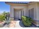 Inviting front entrance with beautiful desert landscaping and a modern security camera for peace of mind at 190 Channel Dr, Henderson, NV 89002