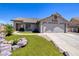 Charming single-story home with a two-car garage, green lawn, and desert landscaping at 190 Channel Dr, Henderson, NV 89002
