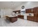 Bright and airy kitchen with a large center island and dark wood cabinets at 190 Channel Dr, Henderson, NV 89002