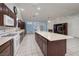 Open kitchen features tile flooring, stainless steel appliances, breakfast bar, and recessed lighting at 190 Channel Dr, Henderson, NV 89002