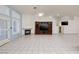 This living room features a fireplace, media center, ceiling fan, tile flooring, and ample natural lighting at 190 Channel Dr, Henderson, NV 89002