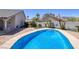Beautiful backyard with a pool, well-maintained landscaping, and a view of the mountains at 190 Channel Dr, Henderson, NV 89002