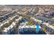 Aerial view of a community with a pool, palm trees, covered parking, and surrounding homes at 2020 Mesquite Ln # 205, Laughlin, NV 89029
