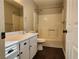 Cozy bathroom featuring a shower-tub combo, single sink vanity, and dark wood-look floors at 2020 Mesquite Ln # 205, Laughlin, NV 89029