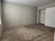 Comfortable bedroom with neutral carpeting, a bright window, and closet storage at 2020 Mesquite Ln # 205, Laughlin, NV 89029