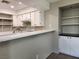 Updated kitchen with bright white cabinetry, breakfast bar, and ample shelving at 2020 Mesquite Ln # 205, Laughlin, NV 89029