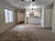 Open living room view of kitchen with breakfast bar, chandelier lighting and ample space at 2020 Mesquite Ln # 205, Laughlin, NV 89029