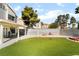 Backyard features synthetic grass, brick firepits, concrete, and a privacy wall at 2046 Waverly Cir, Henderson, NV 89014