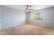 Bedroom with neutral walls, carpet, ceiling fan, and palm tree views at 2046 Waverly Cir, Henderson, NV 89014