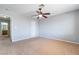 Bedroom with neutral walls, carpet, ceiling fan, access to the bathroom, and closet at 2046 Waverly Cir, Henderson, NV 89014