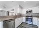 Well-equipped kitchen boasting stainless steel appliances, white cabinetry, and sleek countertops and wood-look tile flooring at 2046 Waverly Cir, Henderson, NV 89014