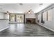 The open-concept living area features wood-look floors, a stone fireplace, and access to the outdoor patio at 2046 Waverly Cir, Henderson, NV 89014