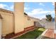 Side yard featuring a red brick walkway and flowerbed with brick border at 2046 Waverly Cir, Henderson, NV 89014
