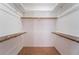 Clean walk-in closet features a single wooden hanging rod and shelving at 2046 Waverly Cir, Henderson, NV 89014