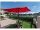 Outdoor patio with a vibrant red umbrella, perfect for enjoying scenic lake views and sunshine at 2529 Seascape Dr, Las Vegas, NV 89128