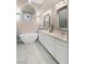 Spa-like bathroom featuring dual sinks, soaking tub, and arched window at 2529 Seascape Dr, Las Vegas, NV 89128