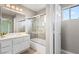 Bathroom featuring combination shower-tub with sliding doors and white vanity at 2529 Seascape Dr, Las Vegas, NV 89128