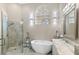 Bathroom features an elegant soaking tub, glass shower, and luxurious marble countertop at 2529 Seascape Dr, Las Vegas, NV 89128