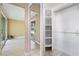 Bright bedroom featuring light wood floors, neutral walls, and a closet with custom shelving at 2529 Seascape Dr, Las Vegas, NV 89128