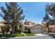 Charming single-Gathering home featuring a well-manicured lawn, mature trees and attached two-car garage at 2529 Seascape Dr, Las Vegas, NV 89128