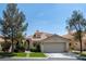 Charming single-Gathering home featuring a well-manicured lawn, mature trees and attached two-car garage at 2529 Seascape Dr, Las Vegas, NV 89128