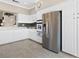 Bright kitchen featuring white cabinetry, stainless steel appliances, and tile flooring at 2529 Seascape Dr, Las Vegas, NV 89128
