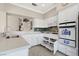 Well-equipped kitchen with white cabinets, tile backsplash, modern appliances, and ample counter space at 2529 Seascape Dr, Las Vegas, NV 89128