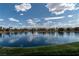 Scenic view of the calm lake reflecting the blue sky and fluffy white clouds at 2529 Seascape Dr, Las Vegas, NV 89128