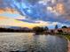Picturesque lake view at sunset, showcasing the water, surrounding homes, and distant mountains at 2529 Seascape Dr, Las Vegas, NV 89128