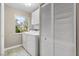 Functional laundry room with white appliances, storage cabinets, and a window at 2529 Seascape Dr, Las Vegas, NV 89128