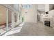 Bright and airy living room featuring large windows, fireplace, and tile flooring at 2529 Seascape Dr, Las Vegas, NV 89128
