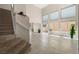 Living room with stairs, large windows, tile floors and neutral colored walls at 2529 Seascape Dr, Las Vegas, NV 89128