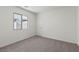 Bedroom with neutral carpet, window, and white walls at 2611 Freya Valley St, Las Vegas, NV 89156