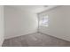 Bedroom with neutral carpet, window, and white walls at 2611 Freya Valley St, Las Vegas, NV 89156