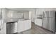 Kitchen with stainless steel appliances, center island with sink and white cabinets and grey countertops at 2611 Freya Valley St, Las Vegas, NV 89156