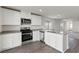 Modern kitchen features stainless steel appliances, white cabinets, and an island with a sink at 2611 Freya Valley St, Las Vegas, NV 89156