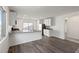 Open kitchen with stainless appliances, island sink, wood flooring and access to carpeted living area at 2611 Freya Valley St, Las Vegas, NV 89156