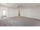 Spacious living room featuring a ceiling fan and neutral carpeting at 2611 Freya Valley St, Las Vegas, NV 89156