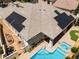 Aerial view of a home featuring solar panels and a pristine pool with lush landscaping and patio at 308 Kingsclear Ct, Las Vegas, NV 89145