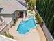 Aerial view of a backyard featuring a pool, spa, and outdoor living area, framed by lush landscaping at 308 Kingsclear Ct, Las Vegas, NV 89145