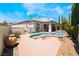 Private backyard with a pool, spa, covered patio, and mature landscaping, ideal for outdoor living at 308 Kingsclear Ct, Las Vegas, NV 89145