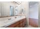 Bathroom featuring double sinks, granite countertops, and tile floors with a doorway to another room at 308 Kingsclear Ct, Las Vegas, NV 89145