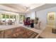 Open dining room with elegant decor, fireplace and lots of natural light from large windows at 308 Kingsclear Ct, Las Vegas, NV 89145