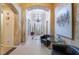 Elegant foyer with arched entryways, chandelier, textured walls, tile flooring, and decorative artwork at 308 Kingsclear Ct, Las Vegas, NV 89145