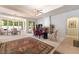 Bright and airy living area with tile flooring, a dining table, and a cozy seating area at 308 Kingsclear Ct, Las Vegas, NV 89145