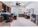 Spacious office featuring custom wooden built-ins, a ceiling fan, and ample natural light at 308 Kingsclear Ct, Las Vegas, NV 89145