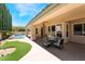 Relaxing covered patio with outdoor seating overlooking the pool and lush backyard at 308 Kingsclear Ct, Las Vegas, NV 89145